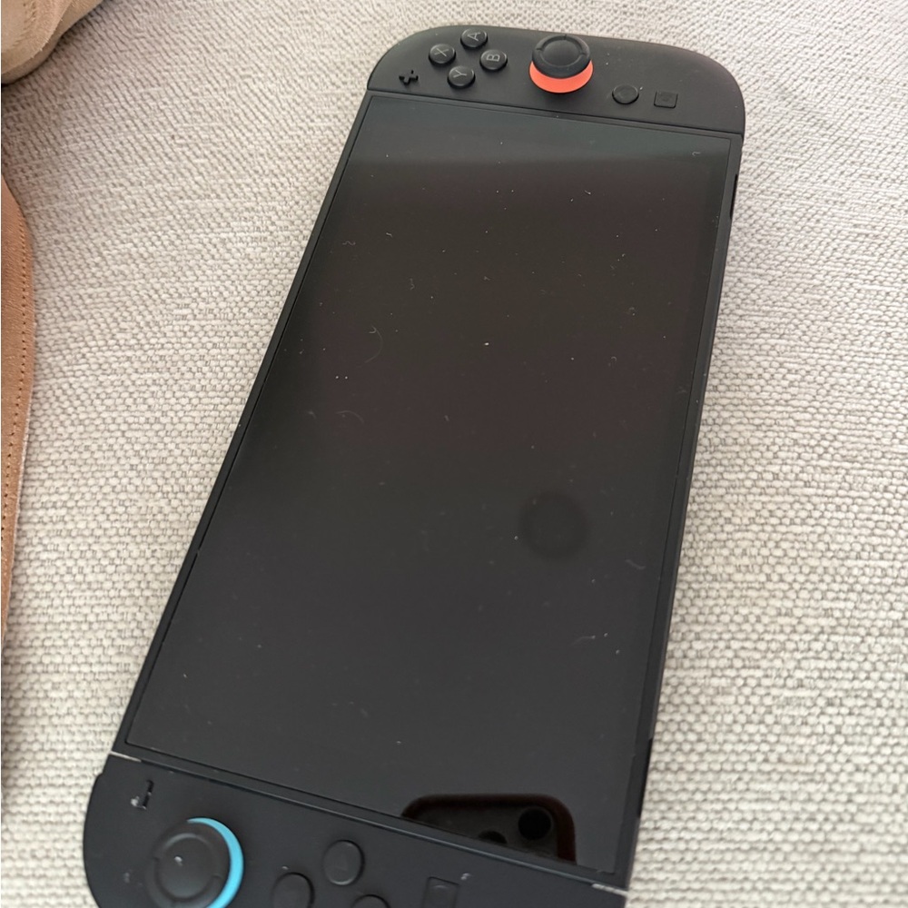 Sleek Black Handheld Gaming Console with Blue and Red Accents